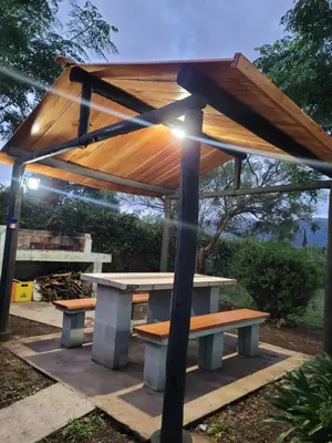 a picnic table with a wooden roof on top at Balcones de Bialet in Bialet Massé