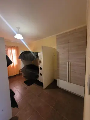 a room with a chair and a desk and a refrigerator at Balcones de Bialet in Bialet Massé