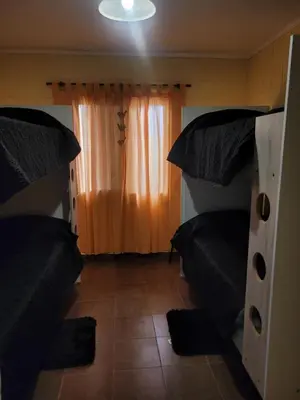 a bedroom with two beds and an orange curtain at Balcones de Bialet in Bialet Massé