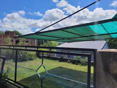 a green canopy on top of a fence at Balcones de Bialet in Bialet Massé