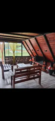 a wooden bench sitting in a room with windows at Las huertitas de Milele
