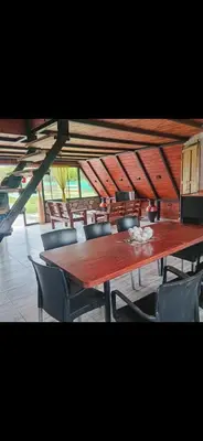 a large wooden table and chairs in a room at Las huertitas de Milele