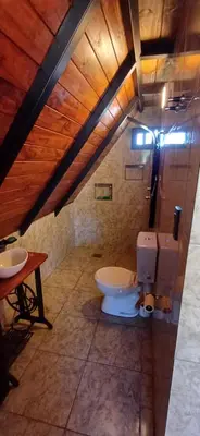 a bathroom with a toilet and a sink at Las huertitas de Milele