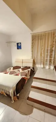 a bedroom with two beds and a window at Casa Céntrica a 4c del rio de 2 Dormitorios para 5 in Villa Carlos Paz