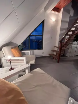 a living room with a staircase and a stair case at Depto mini penthouse in Cordoba