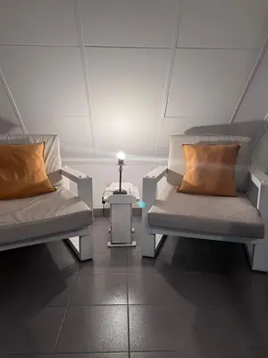 a room with two beds and a table with a lamp at Depto mini penthouse in Cordoba