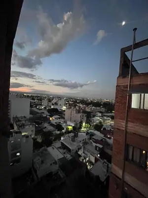 a view of a city at night from a building at Depto mini penthouse in Cordoba