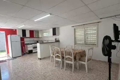 a kitchen with a table and chairs and a refrigerator at Casa El Trapiche Lo Altos in Trapiche