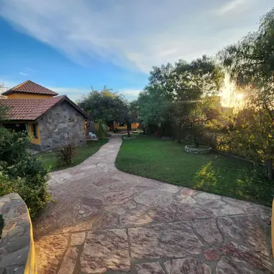 a stone walkway leading to a yard with a house at Merlo Trail Lodge in Merlo