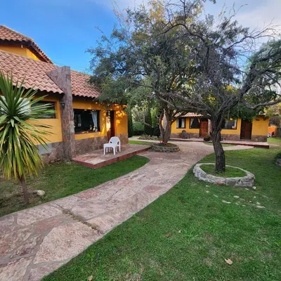 a house with a white bench in a yard at Merlo Trail Lodge in Merlo