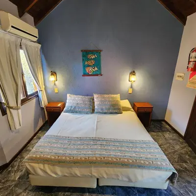 a bedroom with a large bed with two night stands at Merlo Trail Lodge in Merlo