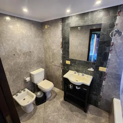 a bathroom with a sink and a toilet and a mirror at Merlo Trail Lodge in Merlo
