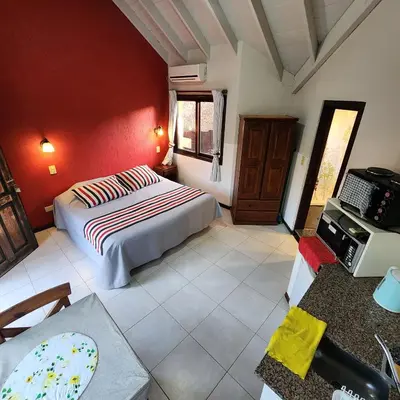 a bedroom with a bed and a desk in a room at Merlo Trail Lodge in Merlo