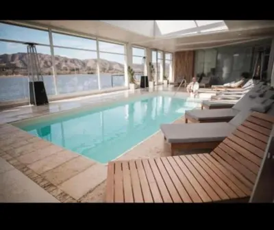 a large swimming pool with lounge chairs at Veneto village depto in Villa Parque Siquiman
