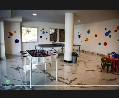 a room with a ping pong table and balls on the wall at Veneto village depto in Villa Parque Siquiman