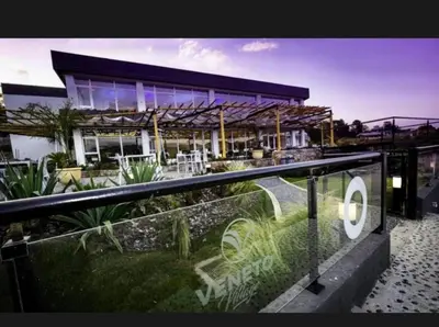 a building with a fence in front of it at Veneto village depto in Villa Parque Siquiman