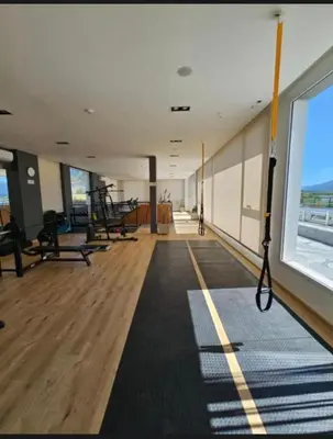 a gym with several treadmills and a large window at Veneto village depto in Villa Parque Siquiman
