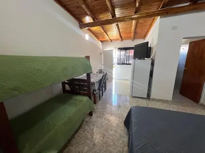 a room with two bunk beds and a refrigerator at Monoambientes Pitu! in Villa Cura Brochero