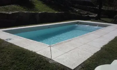 a swimming pool in the middle of a yard at La Morada in Mina Clavero