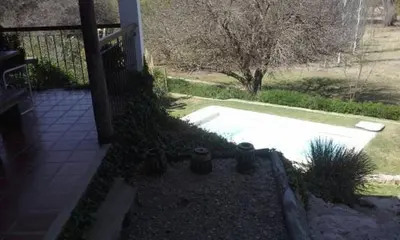 a backyard with a swimming pool and a house at La Morada in Mina Clavero