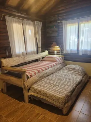 two wooden beds in a room with windows at Alma de Algarrobo in San Javier