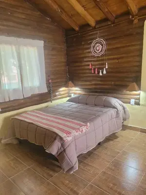 a large bed in a room with wooden walls at Alma de Algarrobo in San Javier