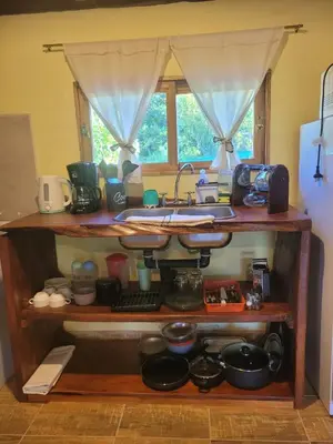 a kitchen shelf with a sink and many dishes at Alma de Algarrobo in San Javier