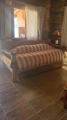 a large wooden bench in a room with a window at Alma de Algarrobo in San Javier
