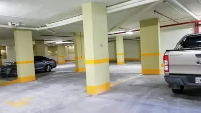 a parking garage with two cars parked in it at Torre Myng in Villa Carlos Paz