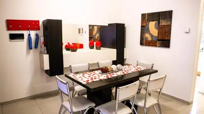 a dining room with a table and chairs at Torre Myng in Villa Carlos Paz