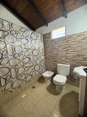 a bathroom with a toilet and a sink at Miraflores in Santa Rosa de Calamuchita