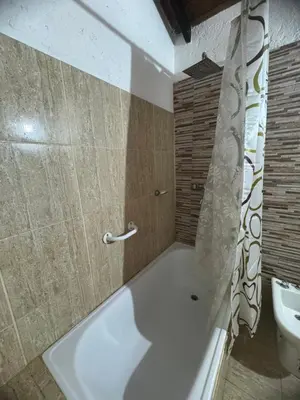 a bathroom with a white tub and a sink at Miraflores in Santa Rosa de Calamuchita