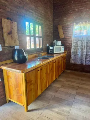 a kitchen with a counter with a sink and a microwave at Miraflores in Santa Rosa de Calamuchita