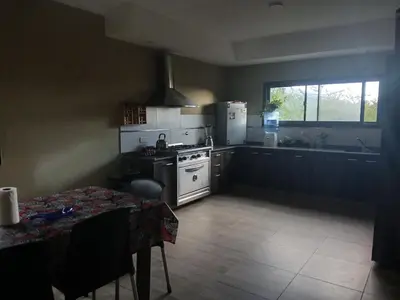 a kitchen with a stove and a table and a window at Torre Fuerte in Cerro de Oro