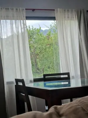 a glass table in front of a window at Torre Fuerte in Cerro de Oro