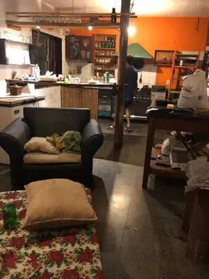 a living room with a couch and a table at Kuku hostel in Las Rabonas