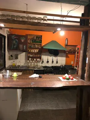 a kitchen with a counter with fruits on it at Kuku hostel in Las Rabonas