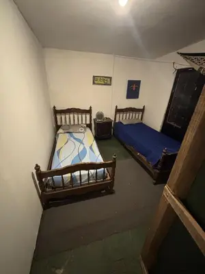a room with two beds in a room at Kuku hostel in Las Rabonas