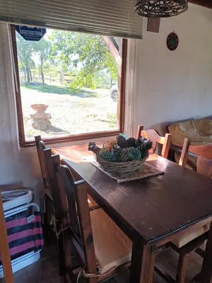 a wooden table with a bowl of fruit on it at Cabaña Buena Vista Los Reartes in Los Reartes