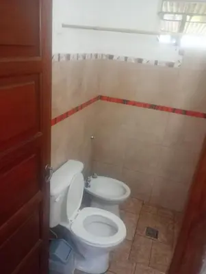 a bathroom with a toilet and a sink at La casita de Mila in Amboy