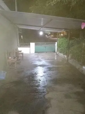 an empty parking garage with water on the ground at La casita de Mila in Amboy