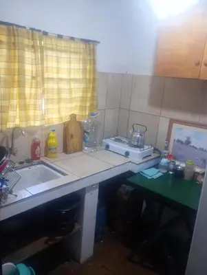 a kitchen with a sink and a counter top with a sink at La casita de Mila in Amboy
