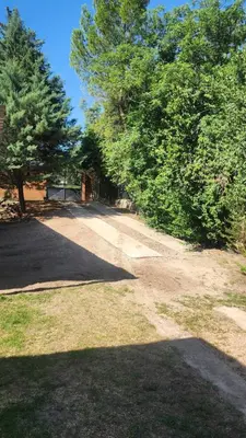 a dirt road in a yard with trees at Apart Playas de Oro in Villa Carlos Paz