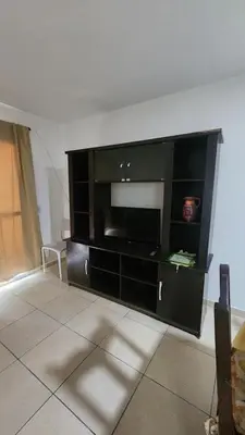 a large black entertainment center in a living room at Apart Playas de Oro in Villa Carlos Paz