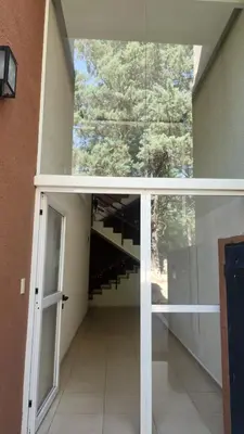 an external view of a building with a glass door at Apart Playas de Oro in Villa Carlos Paz
