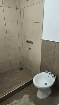 a bathroom with a toilet and a sink at Apart Playas de Oro in Villa Carlos Paz