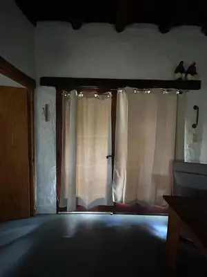 an empty room with a window with curtains at Iris,Tiny house en Las Calles, Traslasierra in Las Calles