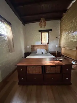 a bedroom with a bed with a wooden dresser at Iris,Tiny house en Las Calles, Traslasierra in Las Calles