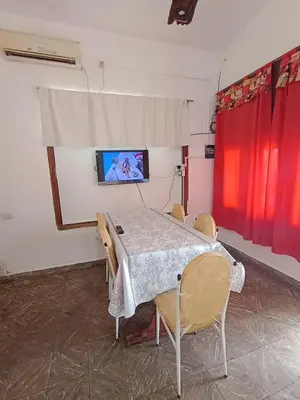 a room with a table and chairs and a tv at chalet los condores in Villa Carlos Paz