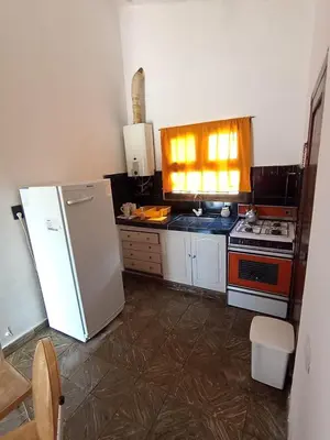 a kitchen with a refrigerator and a stove at chalet los condores in Villa Carlos Paz